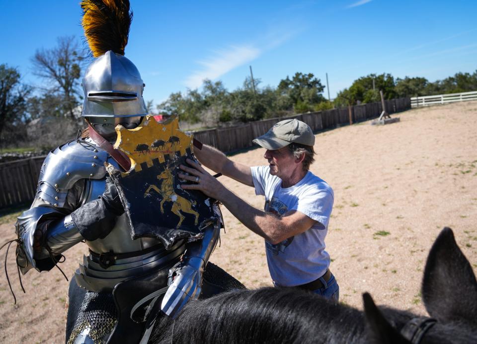 Jousting coach and organizer Steve Hemphill, right, helps Jouster Raven Eastwood prepare to ride in a practice session on Hemphill's property near Leander last month. Hemphill's company, a'Plaisance Ltd., trains jousters and helps organize tournaments.