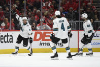 San Jose Sharks left wing Evander Kane (9) celebrates his goal with defensemen Brenden Dillon (4) and Brent Burns (88) during the second period of an NHL hockey game against the Washington Capitals, Sunday, Jan. 5, 2020, in Washington. (AP Photo/Nick Wass)