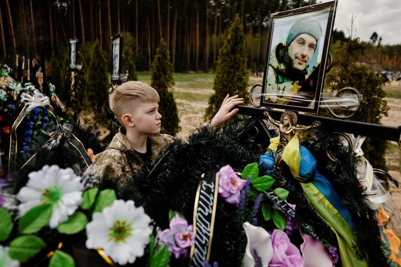 FILE PHOTO: Ukrainians honour fallen soldiers during memorial weekend at the cemetery in Irpin