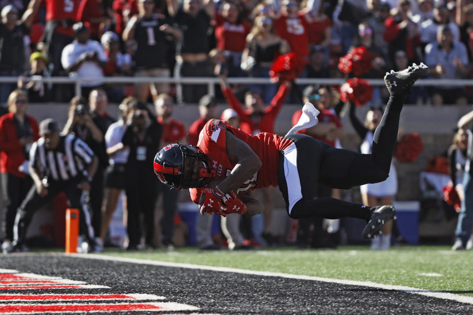 Texas Tech's Myles Price (18) scores a touchdown during the first half of an NCAA college football game against Iowa State, Saturday, Nov. 13, 2021, in Lubbock, Texas. (AP Photo/Brad Tollefson)