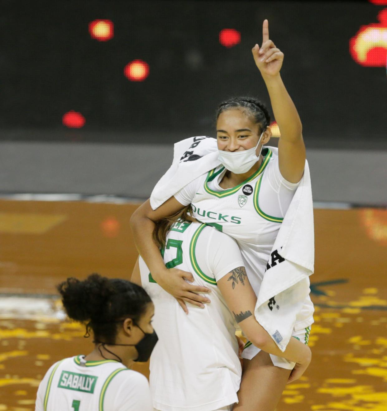 Oregon’s Sedona Prince carries teammate Te-Hina Paopao off the court after a win over Seattle University on Nov. 28, 2020.