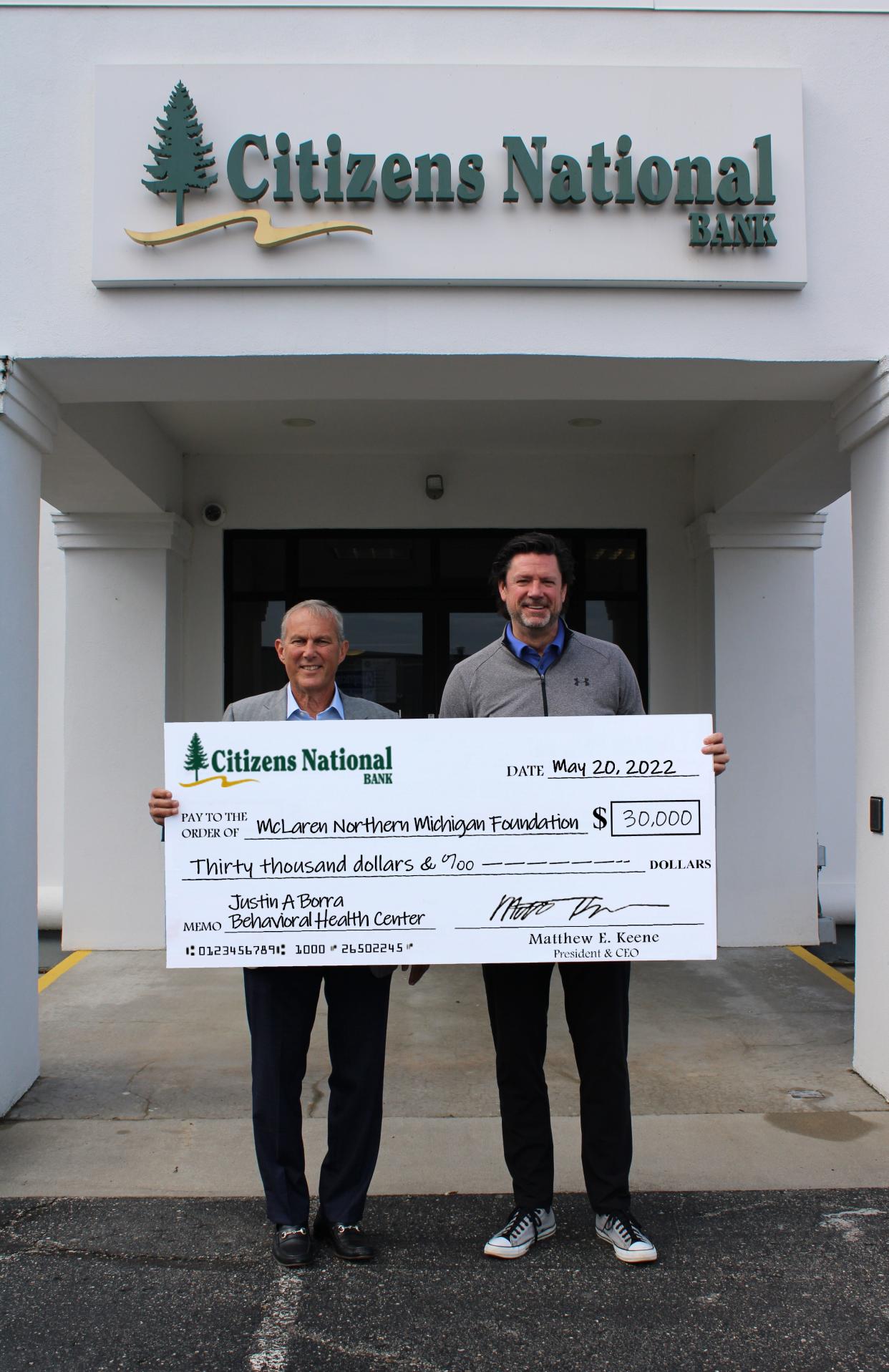 On behalf of their organizations, Dennis Hesselink, McLaren Northern Michigan Board Chair (left), accepts the contribution from Matthew Keene, Citizens National Bank president and CEO, of $30,000 to go toward the new behavioral health center at McLaren Northern Michigan's Cheboygan Campus.