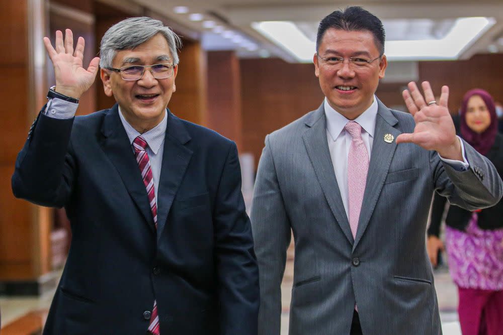 Former Dewan Rakyat Speaker Tan Sri Mohamad Ariff Md Yusof and Deputy Speaker Nga Kor Ming wave at reporters at Parliament July 13, 2020. — Picture by Hari Anggara