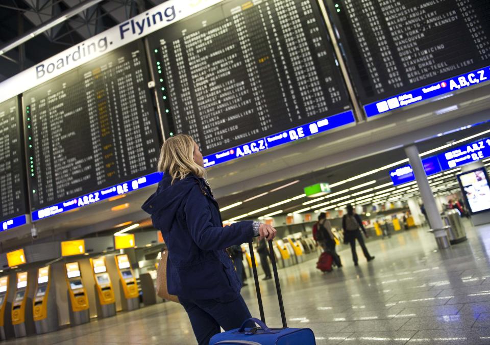 A woman looks at an information board which displays canceled flights at the airport in Frankfurt, Germany, Tuesday March 12, 2013. Due to heavy snowfalls the airport was closed temporarily. (AP Photo/dpa,Nicolas Armer)