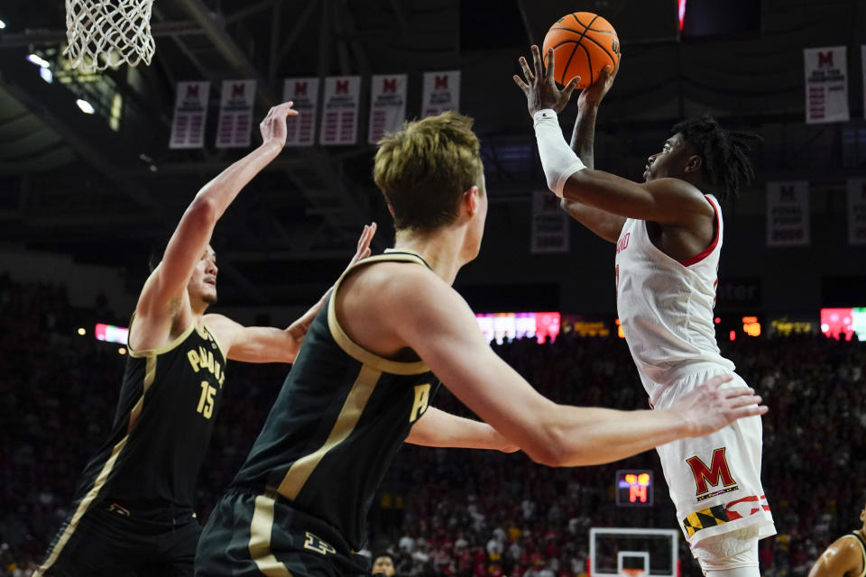 Maryland guard Hakim Hart, right, shoots against Purdue center Zach Edey (15) and guard Fletcher Loyer during the second half of an NCAA college basketball game, Thursday, Feb. 16, 2023, in College Park, Md. Maryland won 68-54. (AP Photo/Julio Cortez)