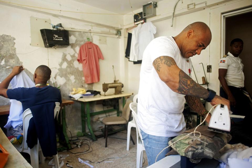 Prisoners work in the tailor's room of the old wing of the Najayo prison which is being renovated in San Cristobal