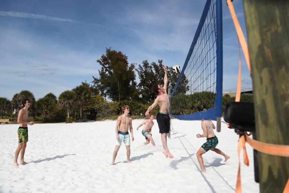 Students on spring break from Iowa play volleyball at Siesta Key Beach.
