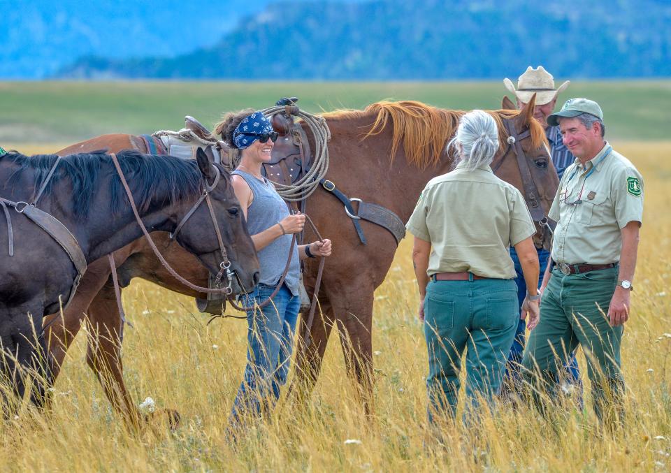 Lanie White, left, who operates the McFarland White Ranch with her father, visits with Carol Hatfield, center, U.S. Forest Service district ranger, and Bill Avey, far right, forest supervisor for Helena-Lewis and Clark Nation Forest, in August 2019  while touring the route of the public access easement across the McFarland White Ranch.