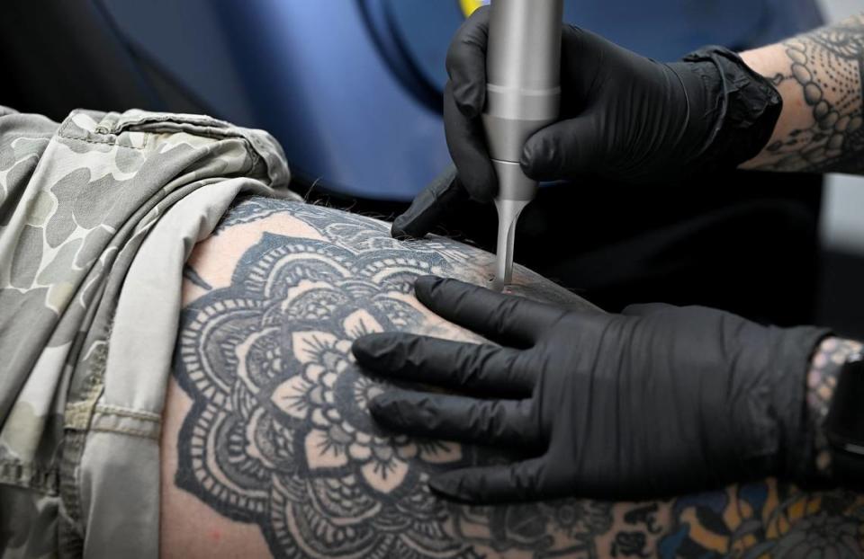 Kelly Crowe works on a laser tattoo removal at Crowe’s Ink. Tattoo in Bradenton.