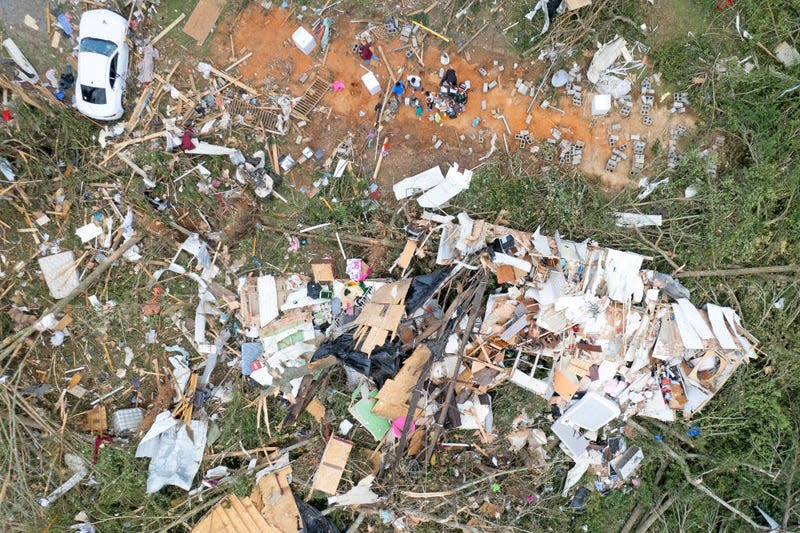In this aerial view, residents attempt to salvage what they can from a destroyed dwelling after a tornado struck off Country Road 16, on June 19, 2023 in Louin, Mississippi.