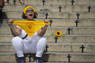 A demonstrator protests against femicides outside the City Council on International Women's Day in Rio de Janeiro, Brazil, Friday, March 8, 2024. (AP Photo/Silvia Izquierdo)