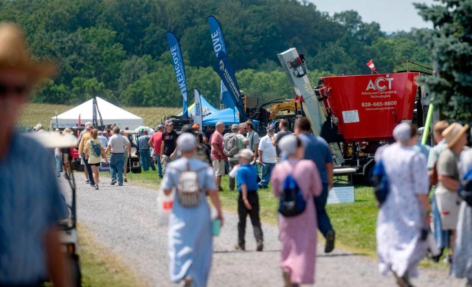 Visitors walk along the displays at the Penn State Ag Progress Days on Wednesday, Aug. 9, 2023.