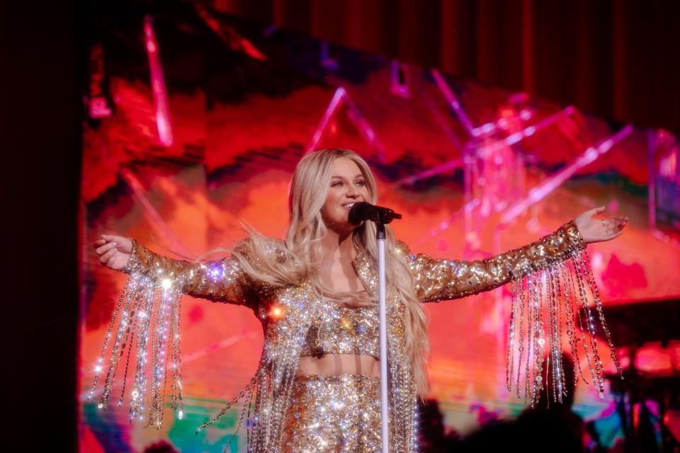 Kelsea Ballerini performing at Radio City Music Hall in a Marc Bouwer ensemble.