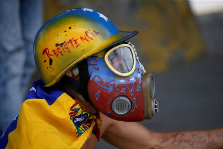 A demonstrator looks on while clashing with riot security forces during a rally against Venezuela's President Nicolas Maduro's government in Caracas, Venezuela, August 12, 2017. REUTERS/Andres Martinez Casares TPX IMAGES OF THE DAY