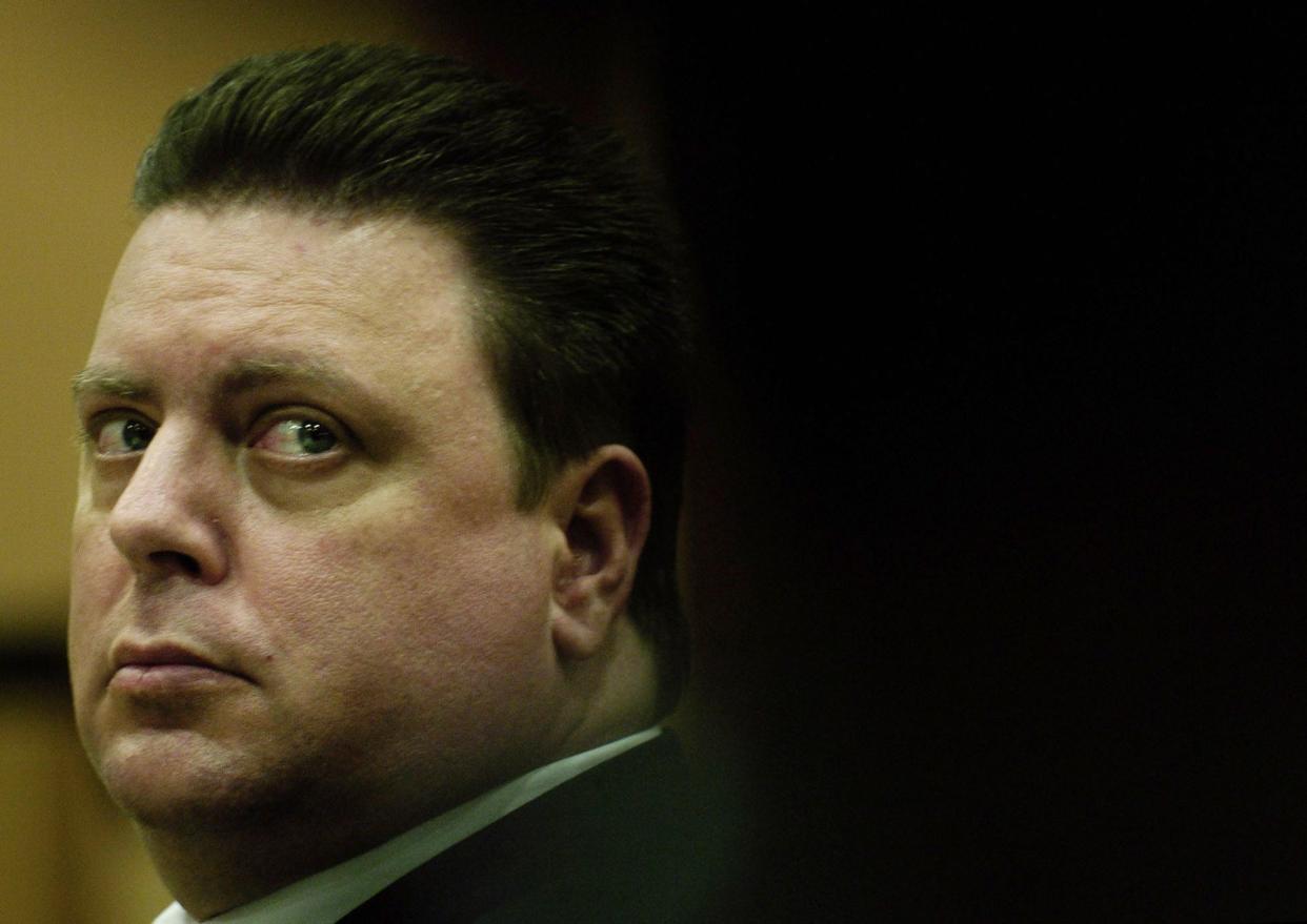 In this  Nov. 7, 2005 file photo, Joseph Smith looks at his public defender while listening to testimony on the first day of his murder trial for the abduction and killing of 11 year-old Carlie Brucia, at the Sarasota County Judicial Center in Sarasota, Fla. 