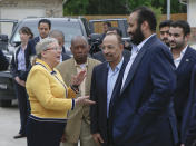 ADDS NAME OF SUSPECT - In this April 7, 2018, file photo, Saudi Crown Prince Mohammed bin Salman, front right, talks with Habitat for Humanity Executive Director Allison Hay, front left, surrounded by his entourage as he tours a flood-damaged area in Houston, Texas. A man, rear second from left, in this image identified by Turkish officials as Maher Abdulaziz Mutreb, also appears in pro-government Turkish newspaper images also showing him on surveillance video walking into the Saudi Consulate in Istanbul before writer Jamal Khashoggi vanished. Saudi Arabia, which initially called the allegations "baseless," has not responded to repeated requests for comment from The Associated Press over recent days, including on Thursday over Mutreb’s identification. (Strever Gonzales/Houston Chronicle via AP)