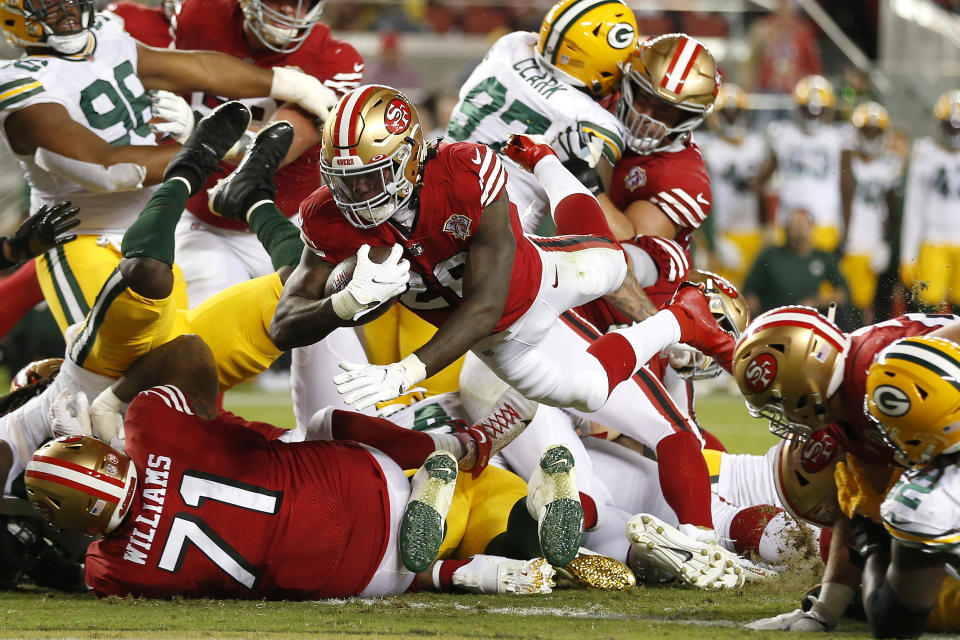 San Francisco 49ers running back Trey Sermon, middle, runs for a touchdown against the Green Bay Packers during the second half of an NFL football game in Santa Clara, Calif., Sunday, Sept. 26, 2021. (AP Photo/Jed Jacobsohn)