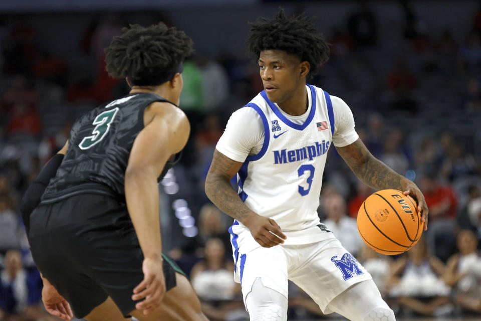 Memphis guard Kendric Davis, right, handles the ball as Tulane guard Jalen Cook, left, defends during first half of an NCAA college basketball game in the semifinals of the American Athletic Conference Tournament, Saturday, March 11, 2023, in Fort Worth, Texas. (AP Photo/Ron Jenkins)