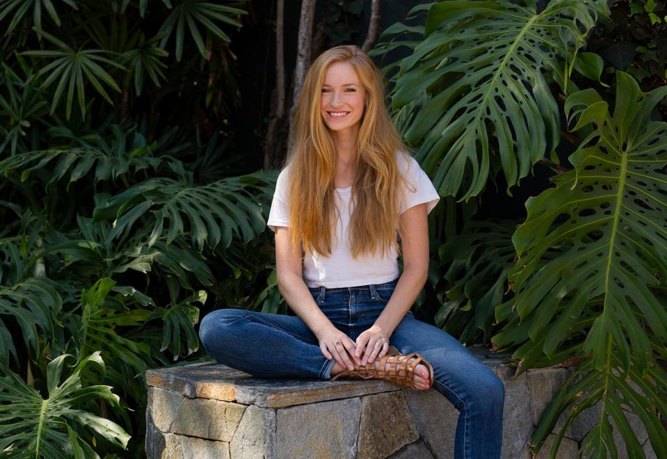 A redhead named Bridget from San Francisco, California, sits outside