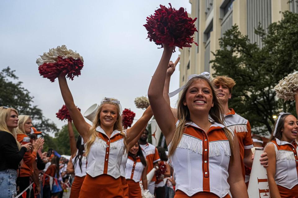 Texas cheerleaders follow the football team into Royal-Memorial Stadium ahead of the Nov. 4 win over Kansas State. The Longhorns went on to the College Football Playoff's final four, and all 19 UT sports programs competed in the NCAA postseason this year.