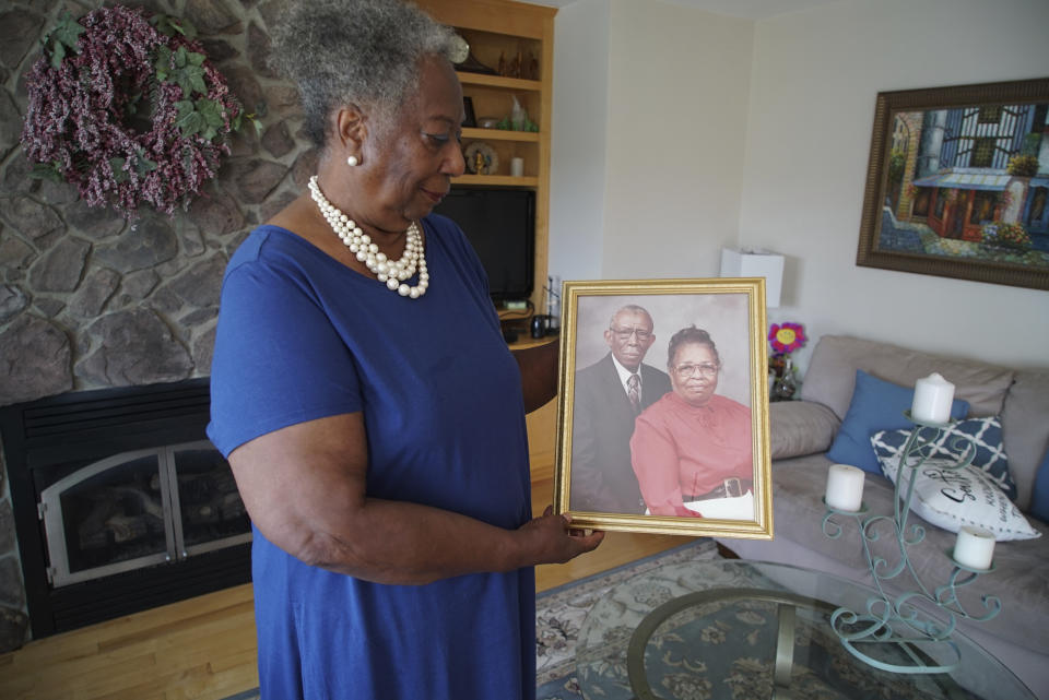 Lillie Tyson Head holds a photograph of her late parents, Freddie Lee and Johnnie Mae Neal Tyson, at her home in Wirtz, Va., on Saturday, July 23, 2022. Freddie Tyson was part of the infamous "Tuskegee Study," in which hundreds of Black men in Alabama went untreated for syphilis for decades so federal government researchers could record the disease's affects on the body. Head says her mother was later tested, and did not have the disease. (AP Photo/Allen G. Breed)