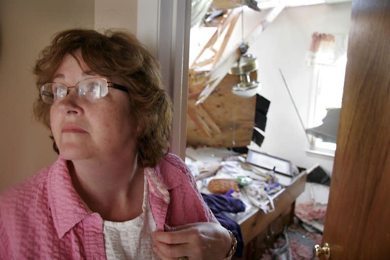 Deborah Davis looks over the damage to her home on Hayes Fork Road in Gloucester, Virginia. The worst tornadoes to hit parts of the United States in decades have left 44 people dead, stripping roofs off houses and tossing mobile homes into the air like toys, emergency officials said Sunday