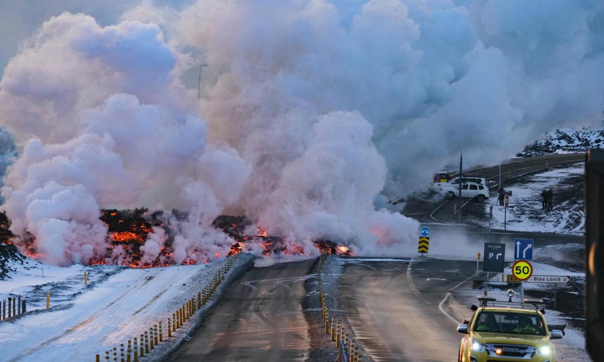<span>Molten lava overflowing on to the road leading to the Blue Lagoon near Grindavík.</span><span>Photograph: Kristinn Magnusson/AFP/Getty Images</span>