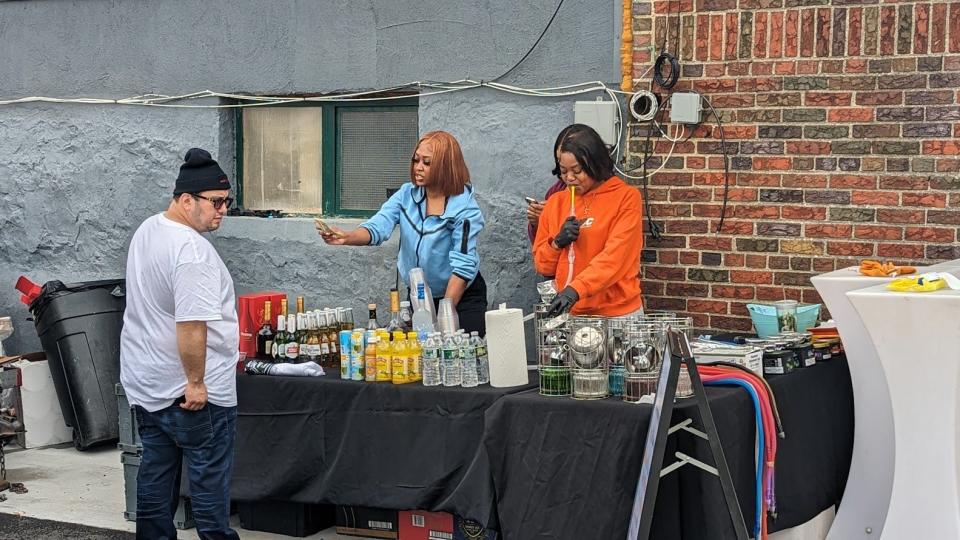 A patron of Elevate's 4/20 party pondered purchasing an alcoholic drink in the dispensary's parking lot, where beer, wine or hard liquor drinks were for sale.
