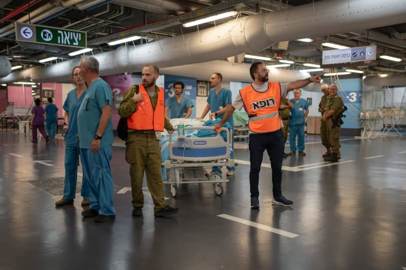 Paramedics assist medical staff at Rambam Hospital in transporting patients from the upper floors to an underground parking area following an attack by the pro-Iranian Hezbollah movement. Ilia Yefimovich/dpa