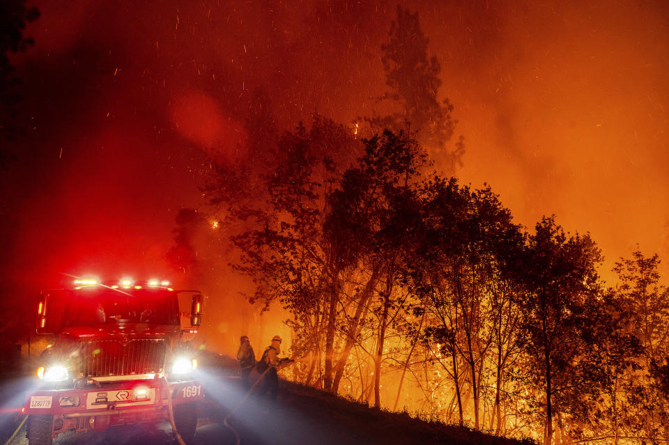 Firefighters battle the Mosquito Fire burning on Michigan Bluff Rd. in unincorporated Placer County, Calif., on Wednesday, Sept. 7, 2022. (AP Photo/Noah Berger)