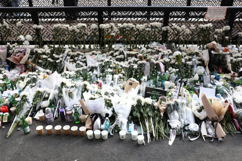 Flowers are laid for tribute the victims of the Halloween celebration stampede on the street near the scene (Getty Images)