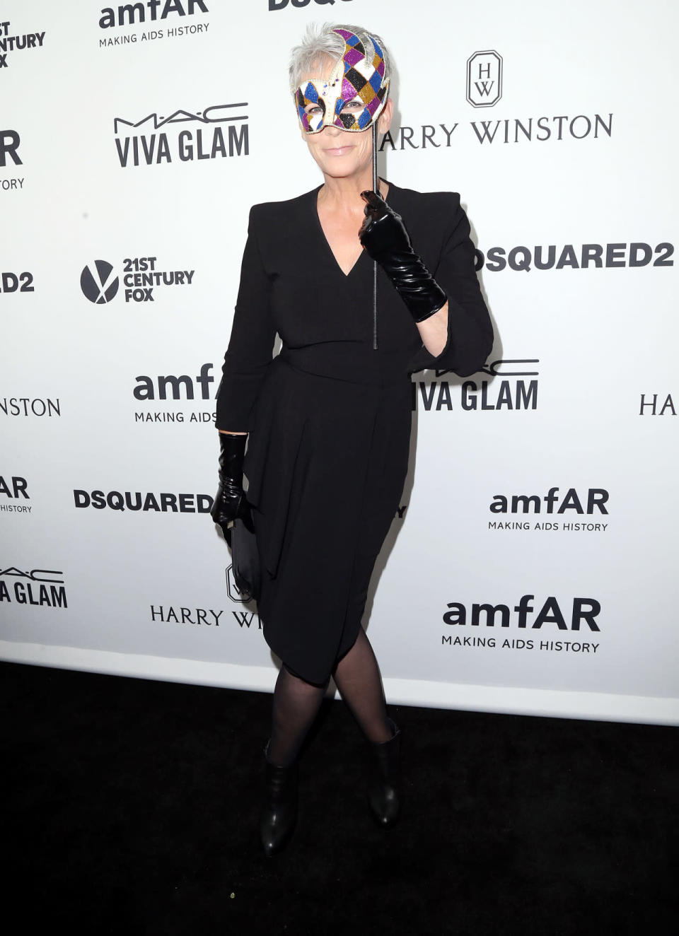 Jamie Lee Curtis added a masquerade touch to her all black ensemble at amfAR’s Inspiration Gala Los Angeles.