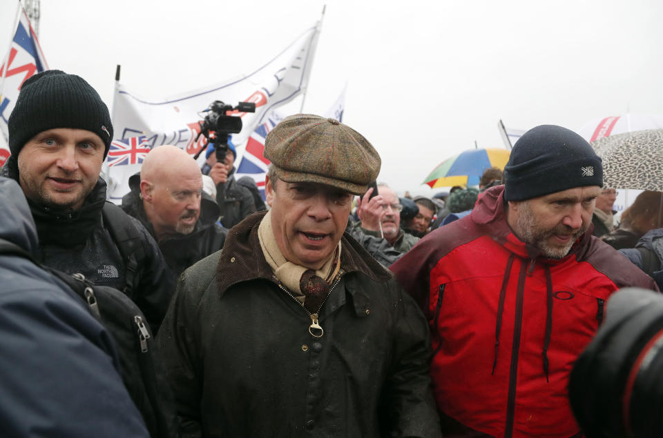 Former UKIP party leader Nigel Farage, centre, joins the start of the first leg of March to Leave the European Union, in Sunderland, England, Saturday, March 16, 2019. Hard-core Brexiteers led by former U.K. Independence Party leader Nigel Farage set out on a two-week "Leave Means Leave" march between northern England and London, accusing politicians of "betraying the will of the people." (AP Photo/Frank Augstein)