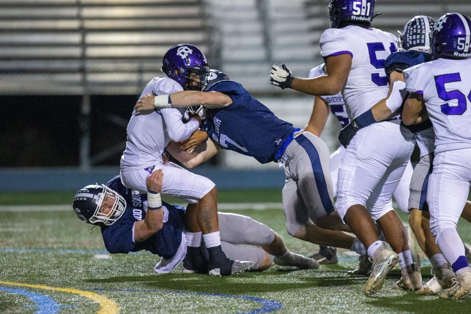 Cherry Hill West's Jordon DeJesus Gonzalez is sacked by Middletown South's Colin Gallagher and Luke Wafle during the first half of the Cherry Hill West vs. Middletown South NJSIAA Central Group 4 playoff football game at Middletown High School South in Middletown, NJ Friday, October 28, 2022. 