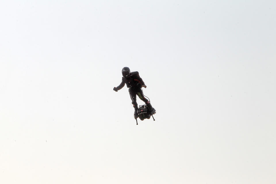 Franky Zapata, a 40-year-old inventor, takes to the air in Sangatte, Northern France, at the start of his attempt to cross the channel from France to England Thursday July 25, 2019. Zapata is anchored to his flyboard, a small flying platform he invented, taking off from Sangatte, in France's Pas de Calais region, and flying to the Dover area in southeast England. (AP Photo/Michel Spingler)