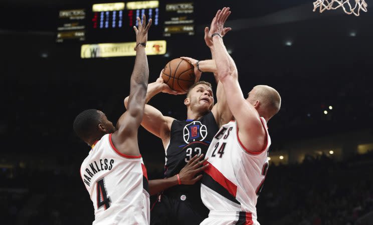 Blake Griffin goes up for a shot against two Blazers defenders. (Associated Press)