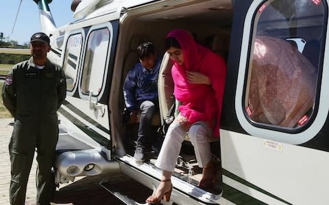 Malala Yousafzai arrives by helicopter to the all-boys Swat Cadet College Guli Bagh, during her hometown visit - Credit:  ABDUL MAJEED/ AFP