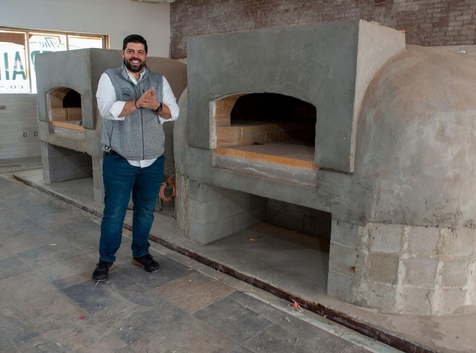 Michael Kasseris, co-founder of Rail Trail Flatbread Co., stands in front of a newly built wood-fired flatbread oven at the restaurant's new Milford location, April 26, 2023. Kasseris said Rail Trail Flatbread hopes to open in Milford this summer.