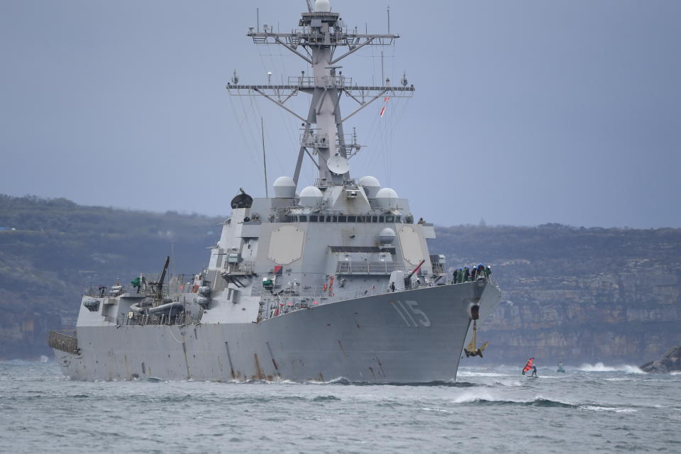 SYDNEY, AUSTRALIA - JULY 10: A kite surfer surfs close to the USS Rafael Peralta, an Arleigh Burke-class destroyer in the US Navy, as she arrives into Sydney Harbour on July 10, 2021 in Sydney, Australia. The warships from four nations are returning to Sydney following warfighting exercise Pacific Vanguard. The HMAS Brisbane (Royal Australian Navy), JS Makinami (Japanese Maritime Self-Defence Force), ROKS Wang Geon (Republic of Korea Navy) and USS Rafael Peralta (United States Navy) all took part in Pacific Vanguard, which was held in Australian waters for the first time. The visiting ships will conduct a COVIDSafe, contactless resupply and refuel at Fleet Base East before departing Sydney. (Photo by James D. Morgan/Getty Images)