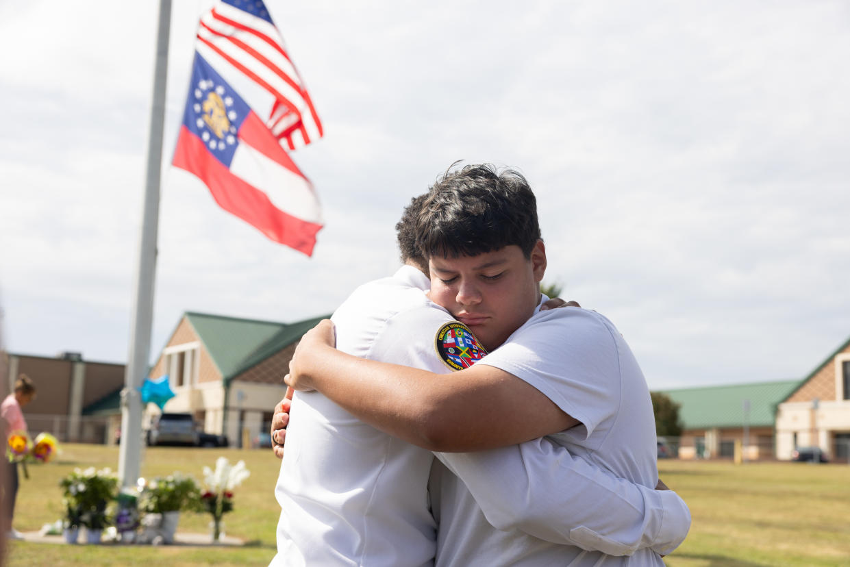  Jose Ortiz, a 14-year-old student and friend of one of the victims, is consoled at Apalachee High School  in Winder, Ga. 