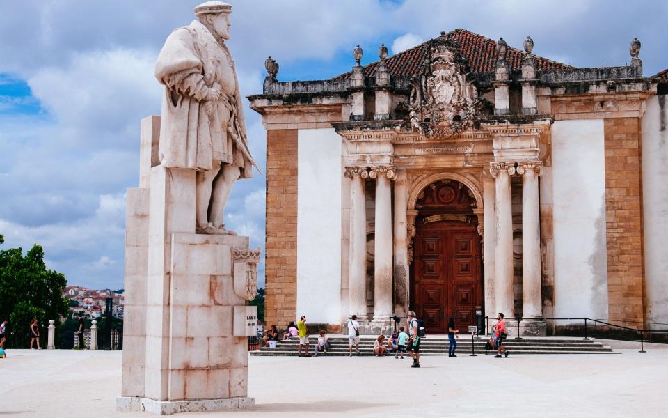 People gathered in front of the library at the University of Coimbra - Getty