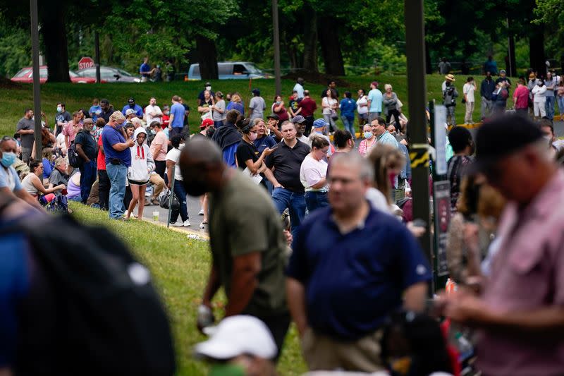 FILE PHOTO: Hundreds of people line up outside a Kentucky Career Center hoping to find assistance with their unemployment claim in Frankfort