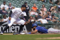 Texas Rangers' Leody Taveras safely beats the tag of Detroit Tigers third baseman Jonathan Schoop during the eighth inning of a baseball game, Wednesday, May 31, 2023, in Detroit. (AP Photo/Carlos Osorio)