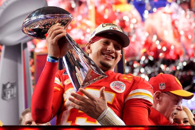 Kansas City Chiefs quarterback Patrick Mahomes celebrates with the trophy