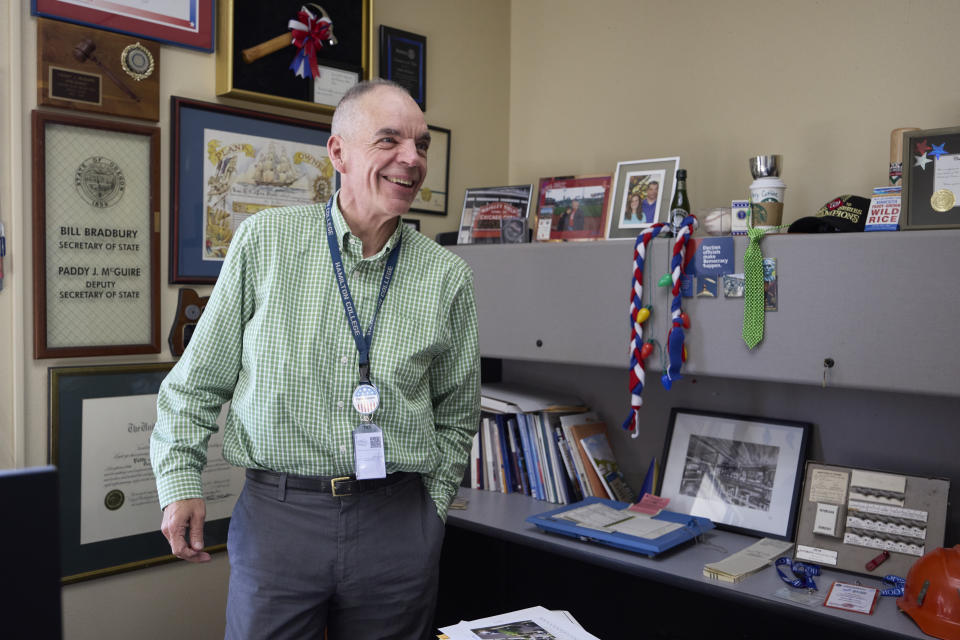 Democrat Paddy McGuire, Mason County auditor, laughs while showing his collection of election memorabilia he has in his office, Thursday, Oct. 13, 2022, in Shelton, Wash.. (AP Photo/John Froschauer)