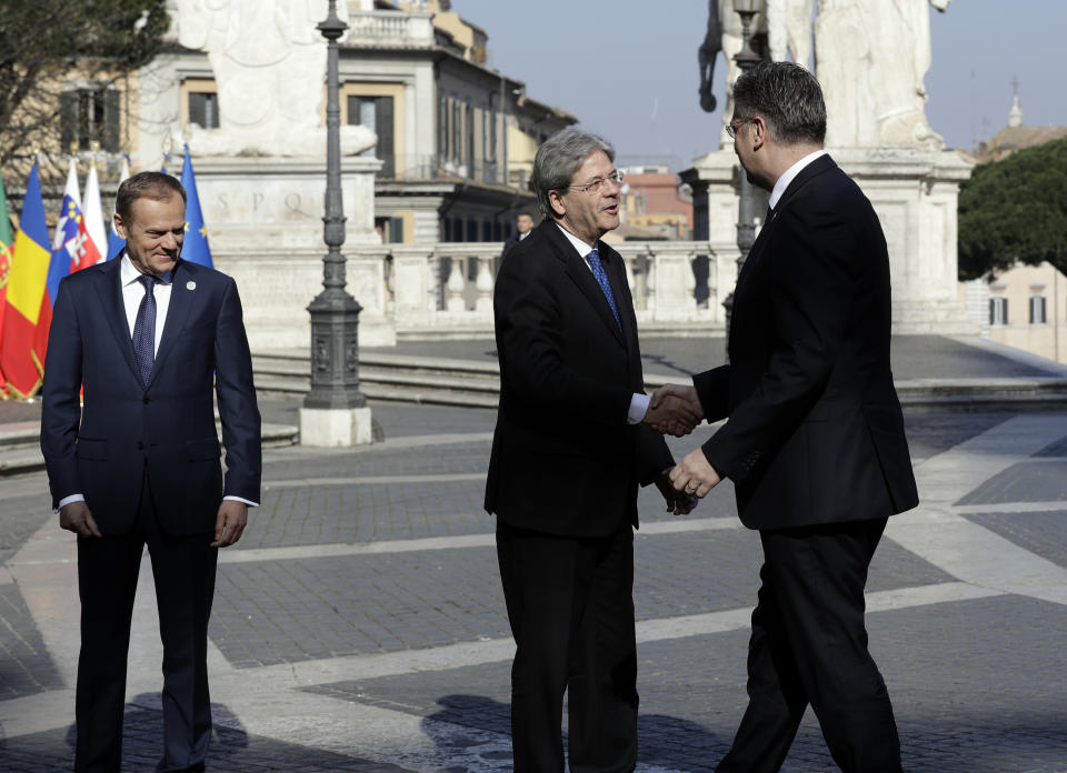 Italian Prime Minister Paolo Gentiloni, center, shakes hands with Croatian Prime Minister Andrej Plenkovic, right, during arrivals for an EU summit at the Palazzo dei Conservatori in Rome on Saturday, March 25, 2017. EU leaders gather in Rome on Saturday to celebrate the 60th anniversary of the EU's founding treaty. (AP Photo/Andrew Medichini)