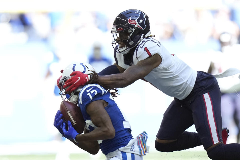 Indianapolis Colts' T.Y. Hilton (13) makes a catch against Houston Texans' Lonnie Johnson (1) during the first half of an NFL football game, Sunday, Oct. 17, 2021, in Indianapolis. (AP Photo/AJ Mast)