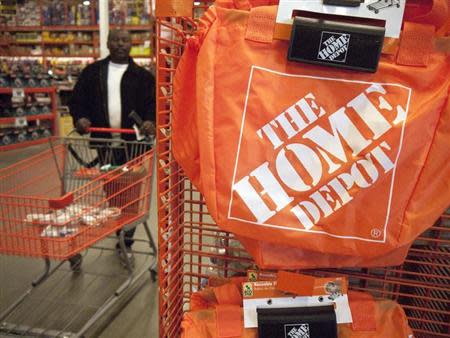 A customer wheels a cart through a Home Depot store in Washington February 20, 2012. REUTERS/Jonathan Ernst