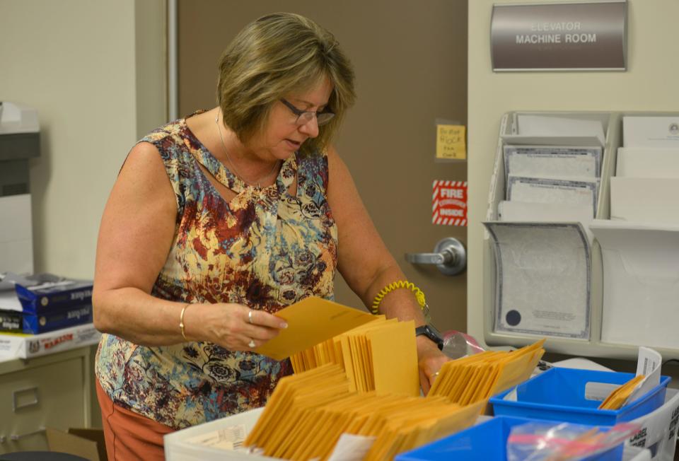 Dennis Town Clerk Theresa Bunce files received ballots in preparation for the primary election on Tuesday.