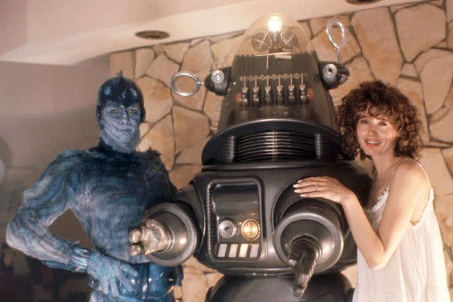 <p>Vestron Pictures/Courtesy Everett Collection</p> Jeff Goldblum, Robby the Robot, and Geena Davis in 'Earth Girls Are Easy'